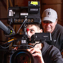 Edoardo Crismani in rear behind the scenes of Deadly Family Portraits: Crombie Crew