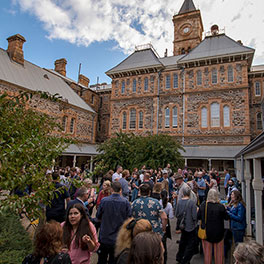 Guests mingling in the historic Adelaide Studios courtyard at the SA Screen Industry Networking event 22 March 2022, photo by Naomi Jellicoe
