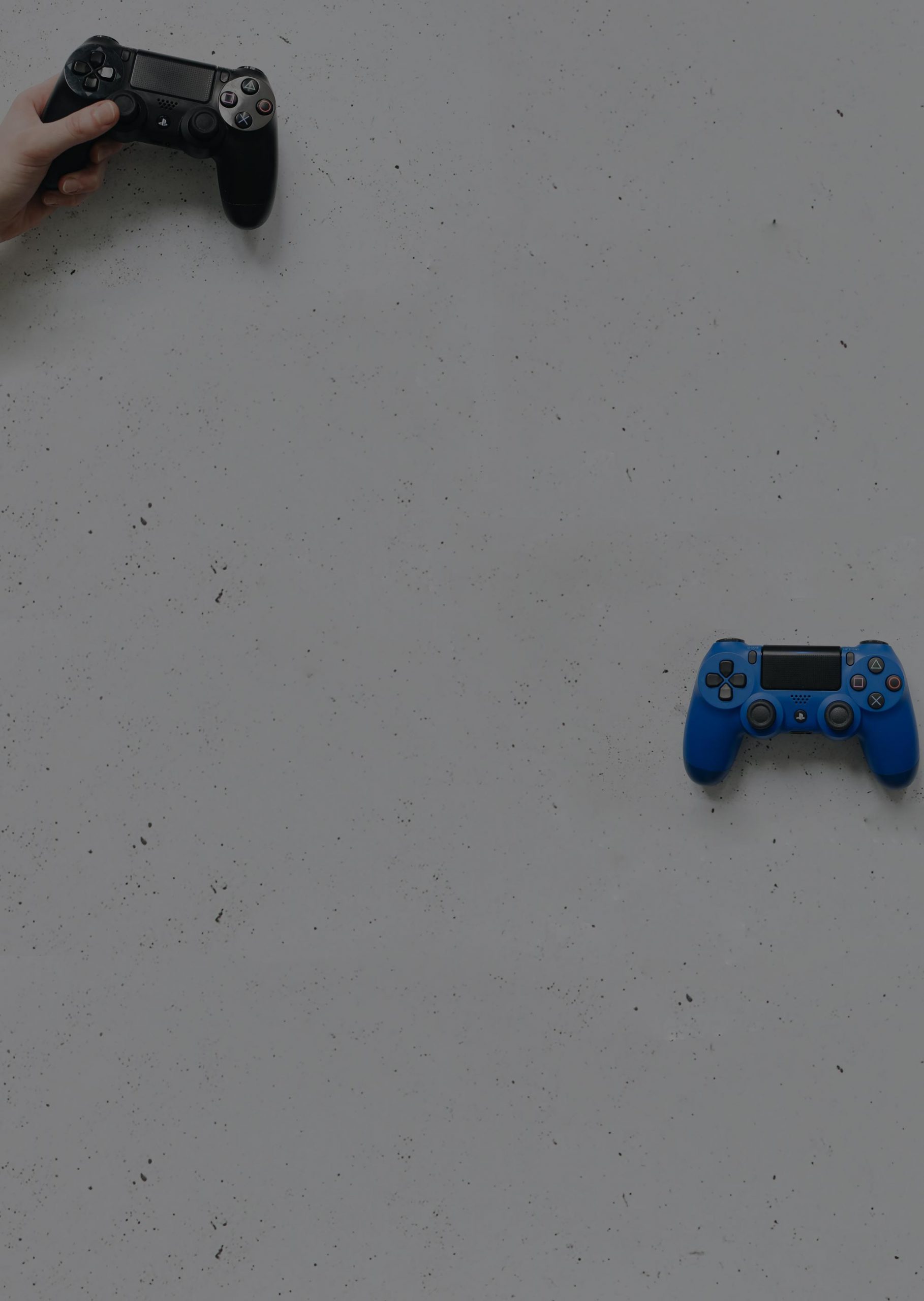 Two game controllers against a white wall