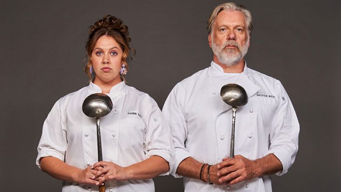 Natalie Abbott and Erik Thomson standing side by side wearing chef's whites and holding ladles