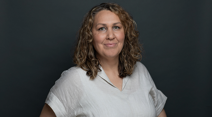 SAFC staff member Tyme Childs in front of a dark grey background