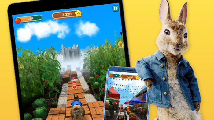 Peter Rabbit pictured with two devices playing the game Peter Rabbit Run!