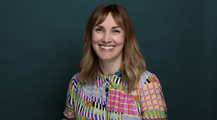 SAFC Board member Clara Reeves in front of a dark green background