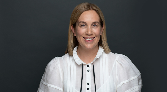 SAFC Head of Finance Emma Henderson in front of a dark grey background