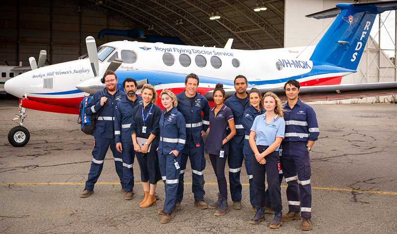 RFDS cast in front of a Royal Flying Doctor Service plane
