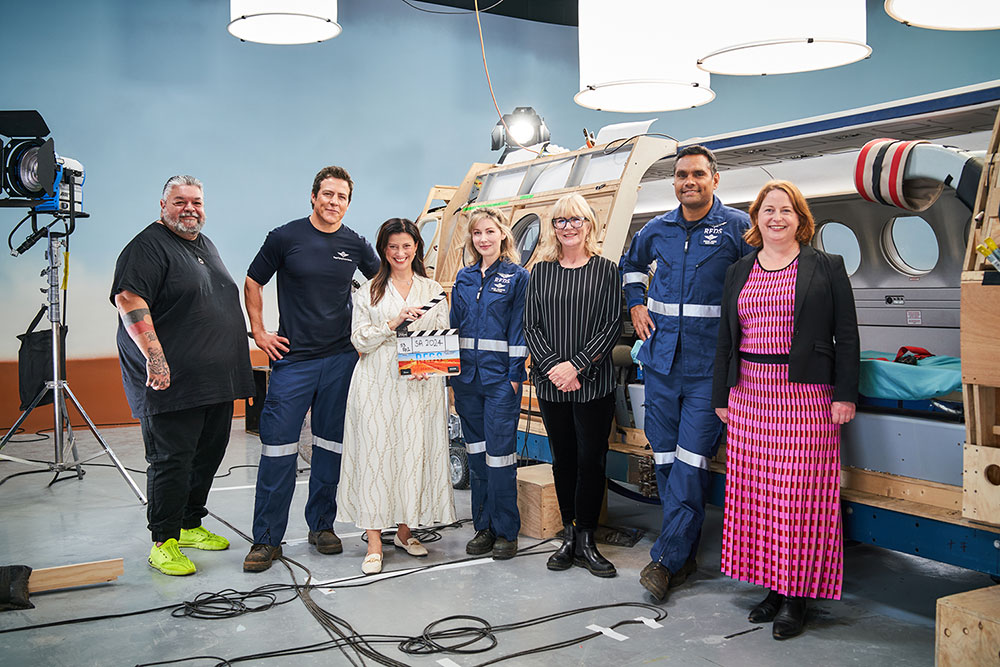 RFDS L-R: Stephen Peacocke, SAFC CEO Kate Croser, Emma Hamilton, Arts Minister Andrea Michaels MP, producer Lisa Scott, Rob Collins and director Adrian Russell Wills on set at the SAFC's Adelaide Studios. Photo credit Ian Routledge