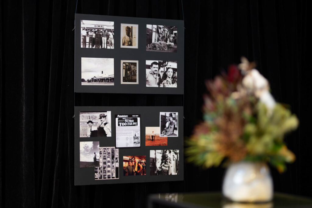 A board displaying photos from Sunday Too Far Away.