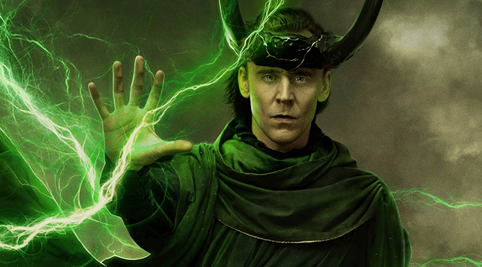 Tom Hiddleston as Loki holds up his hand to command a green lightning bolt.