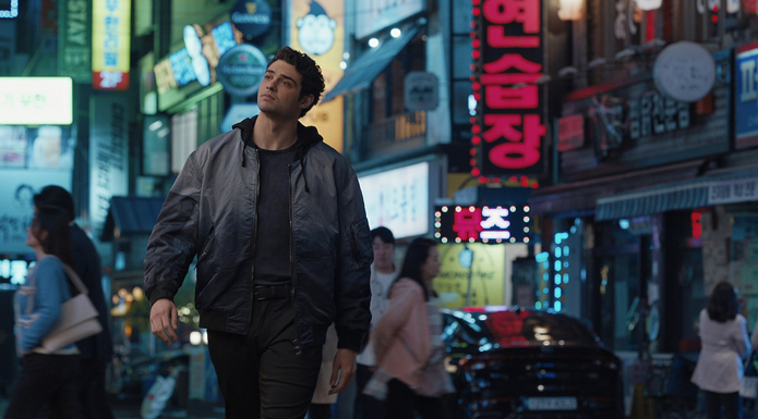 A man walks down a Korean street.